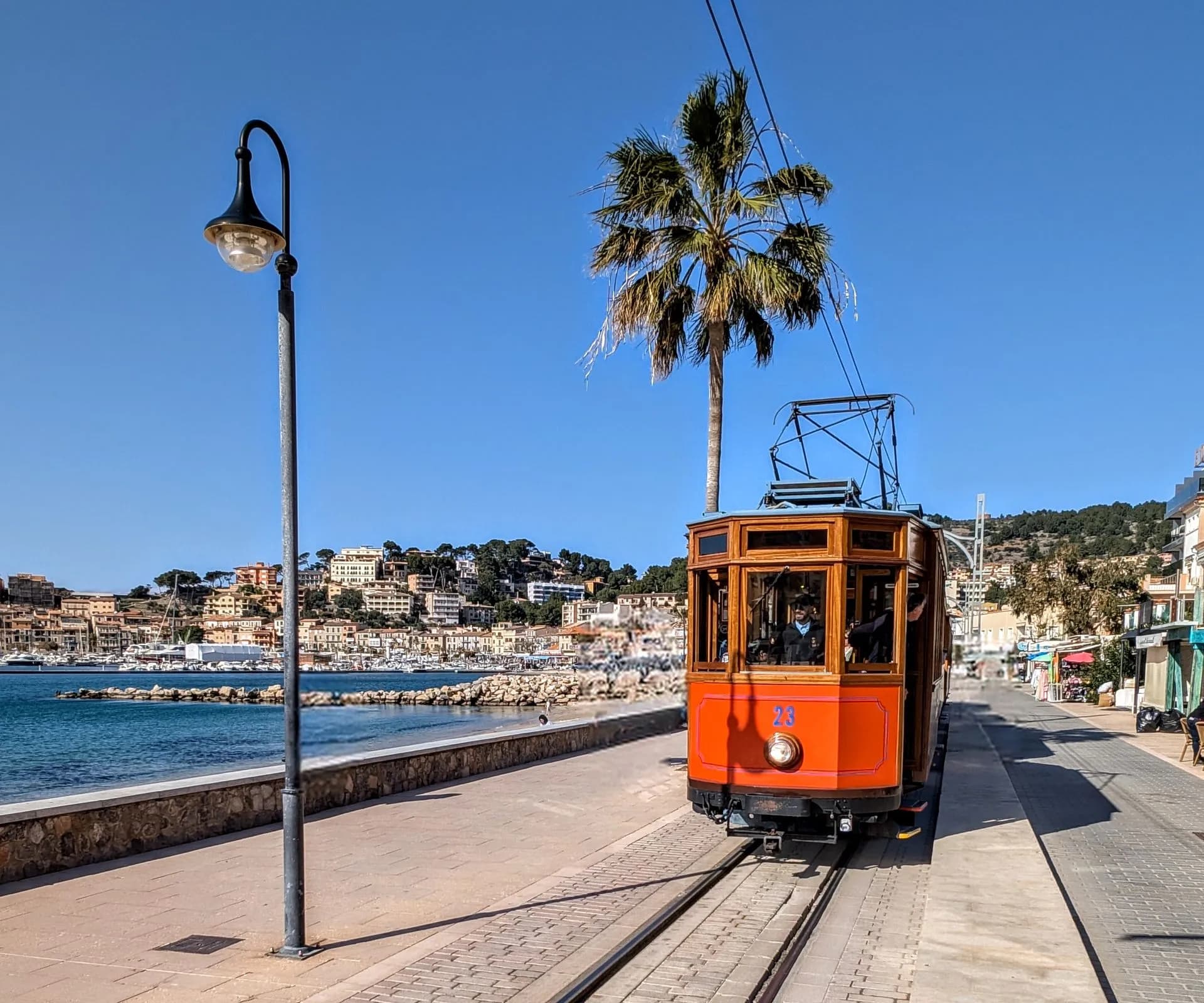 Vintage wooden Sóller train winding through the Tramuntana mountains on a Mallorca island tour