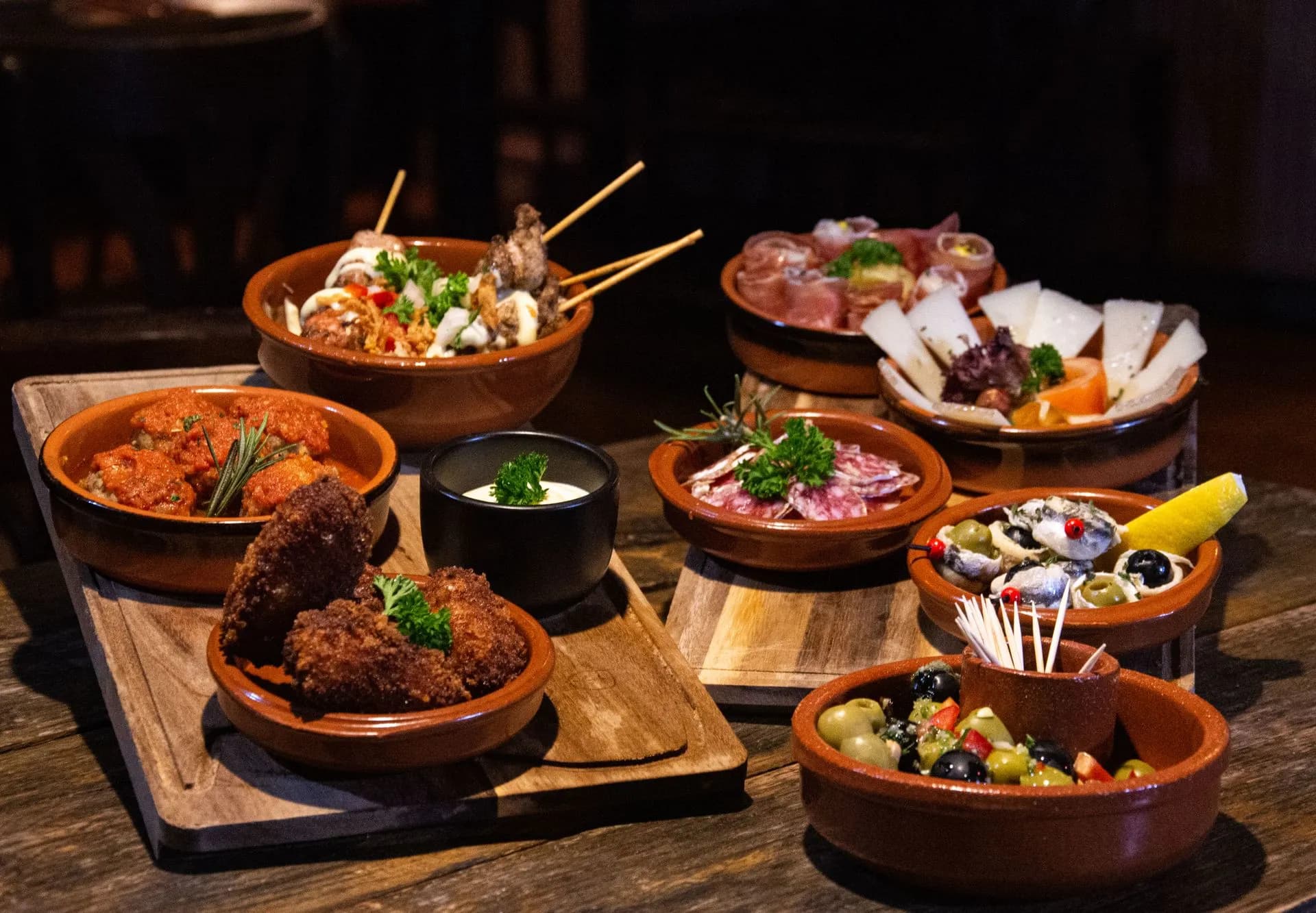 Small group sharing tapas and local wine at a traditional bar on a Barcelona food tour