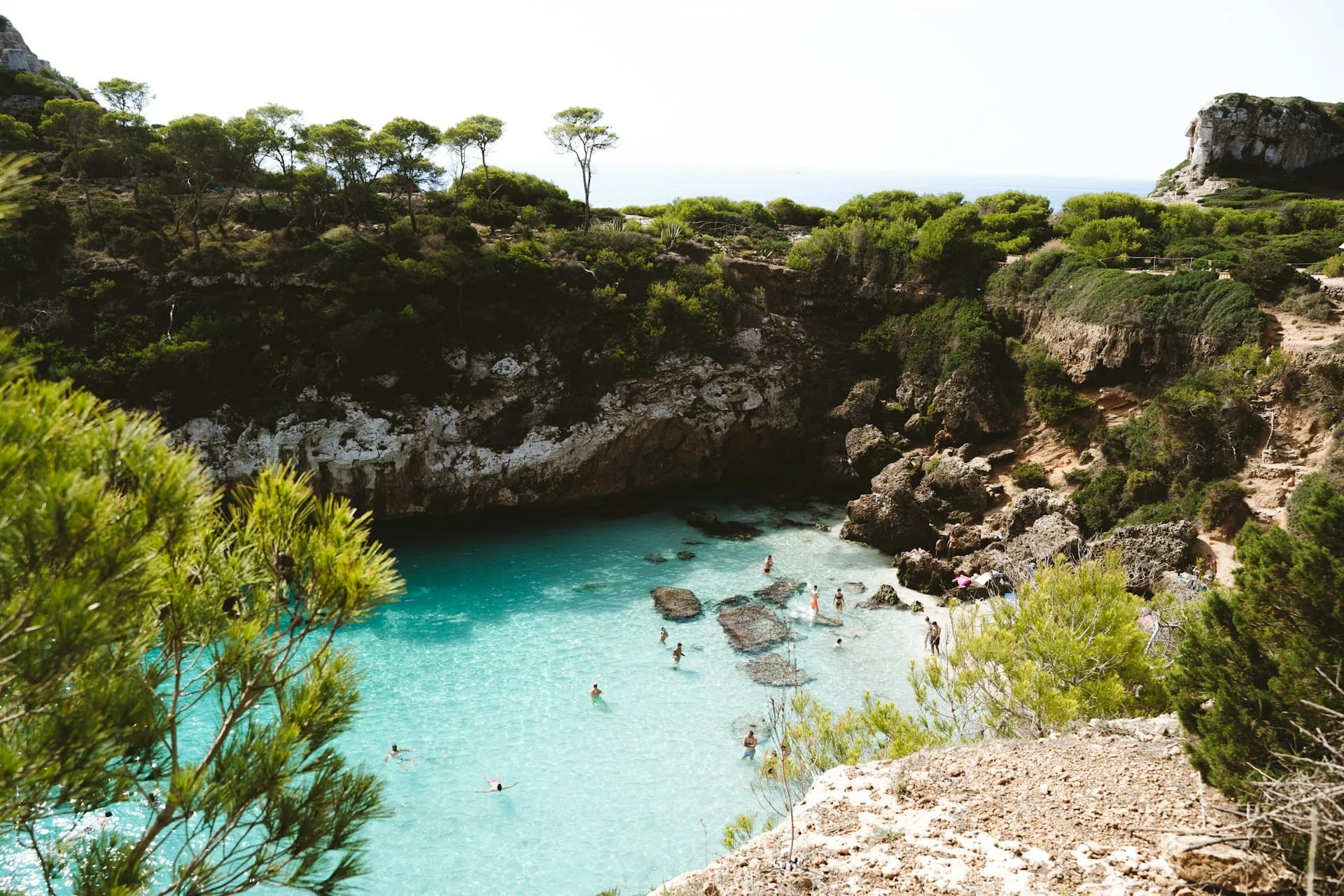 A warm September day at a calm, quieter Mallorca cove with a deep blue sea and golden afternoon light