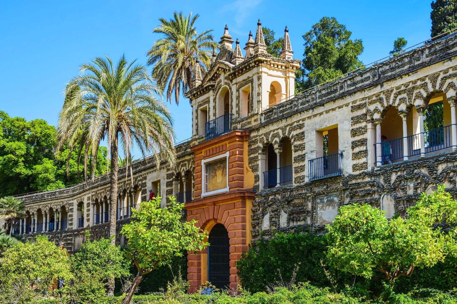 Mudejar arches and tiled courtyard of the Royal Alcázar palace in Seville, Spain
