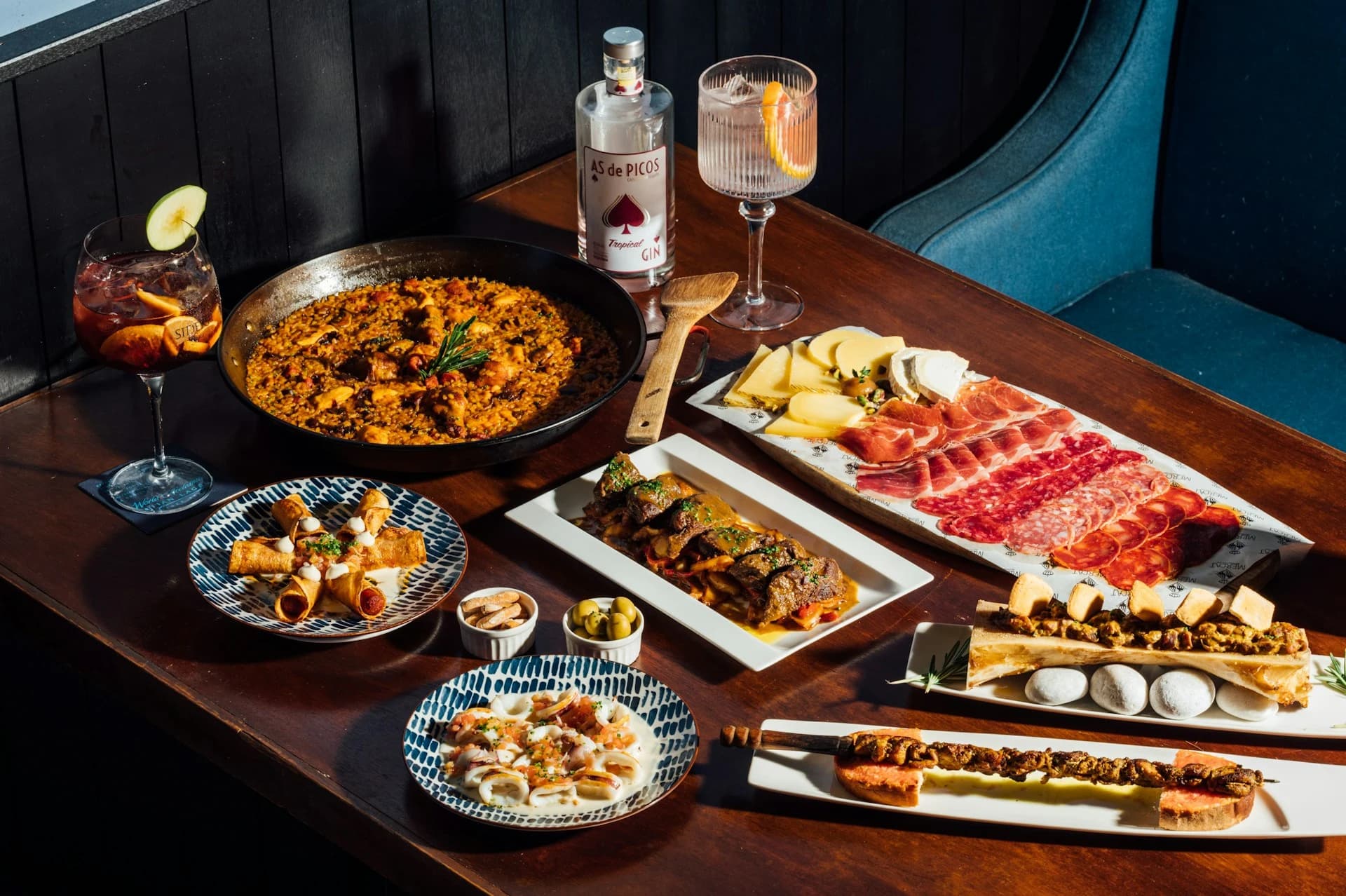 Small group sampling tapas and local wine at a traditional tavern on a Seville food tour