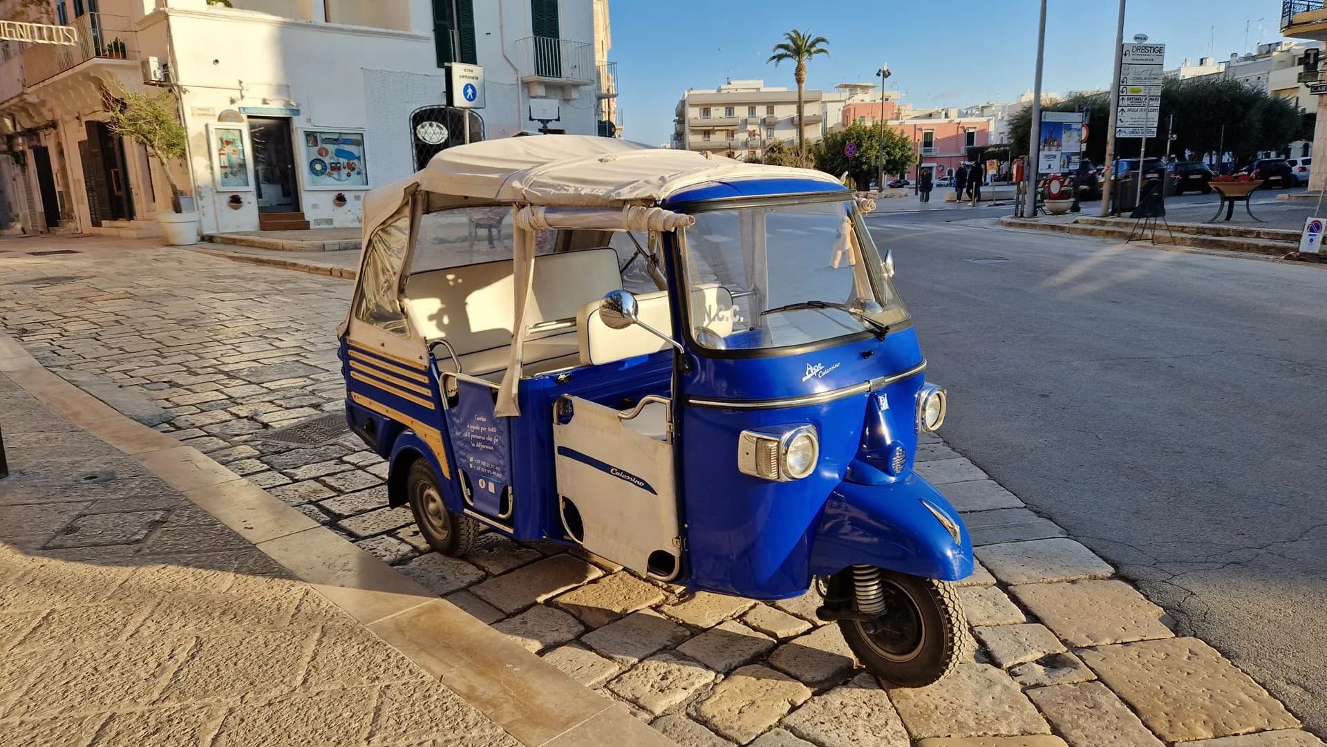 Electric eco tuk tuk on a private city tour passing Plaza de España in Seville, Spain