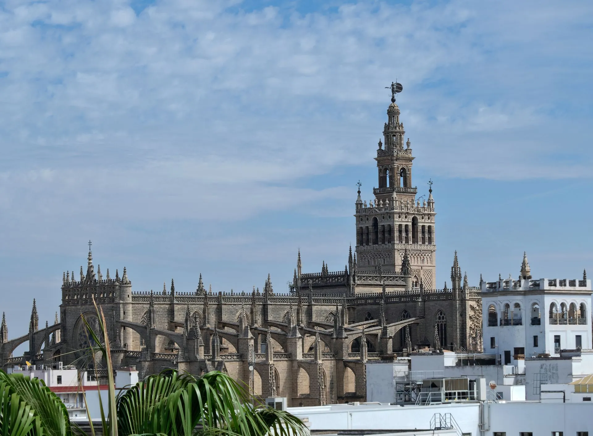 The Giralda bell tower rising above Seville Cathedral against a blue sky in Seville, Spain