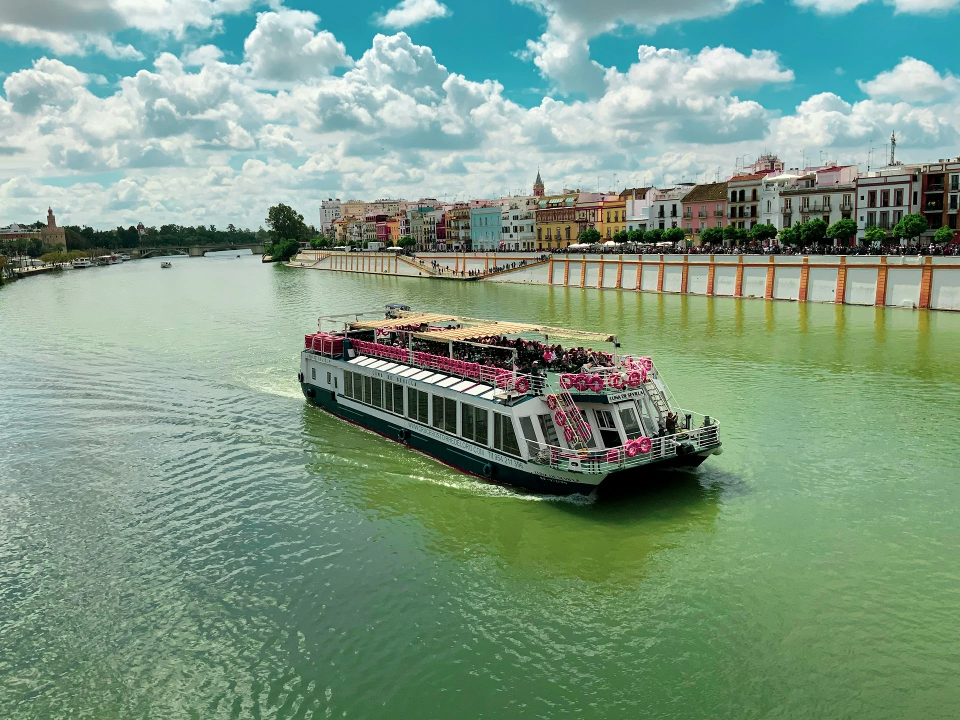 A river cruise passing through the heart of Seville on the Guadalquivir River